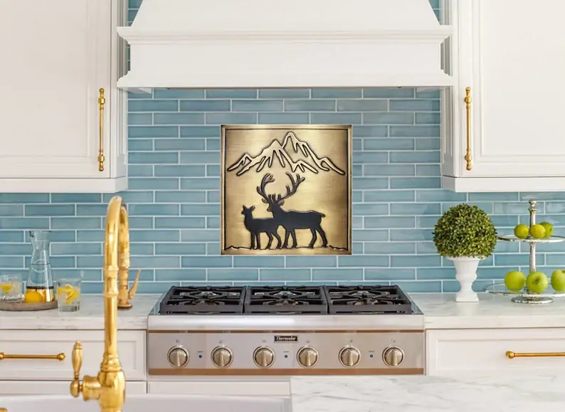 deer and mountain on framed brass 3 tile