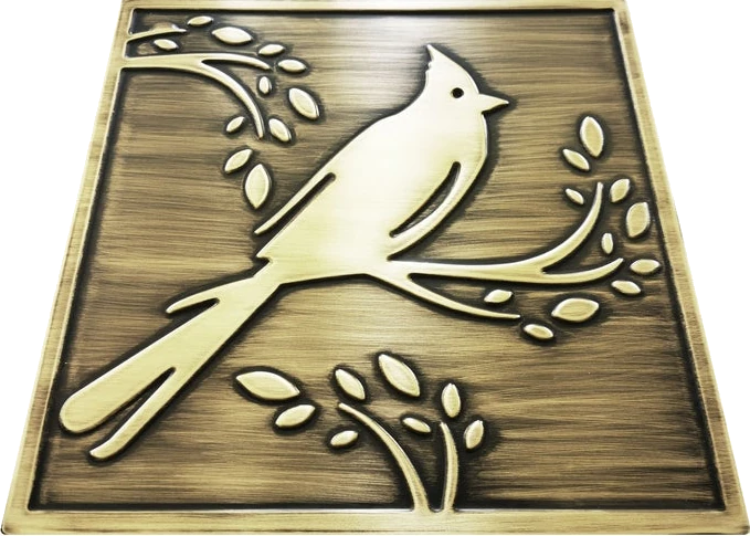 Cardinal bird on a branch on brass tile