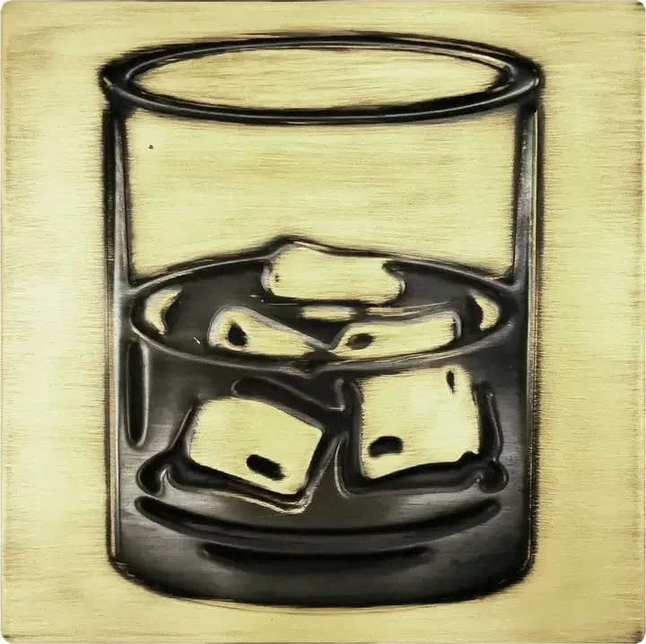 A glass of whiskey on brass tile