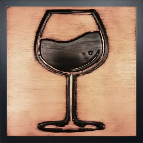 A glass of wine on copper tile in wooden frame