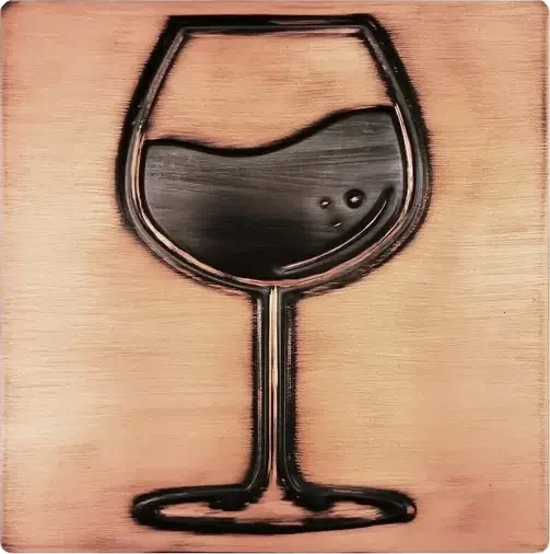 A glass of wine on copper tile