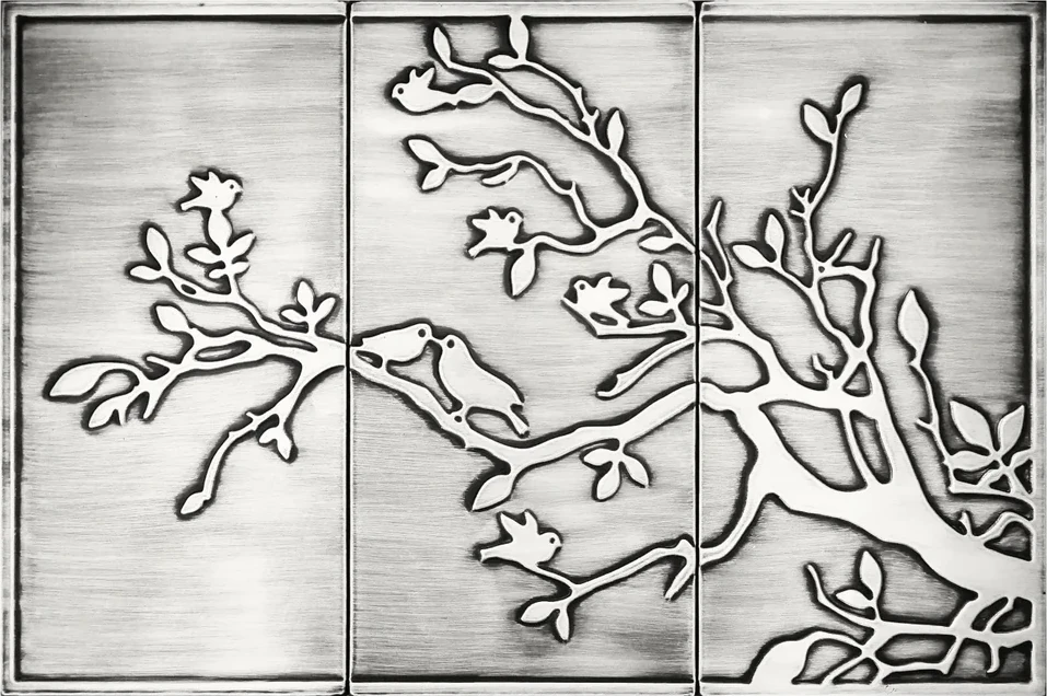 Birds on the branch on three stainless steel tiles