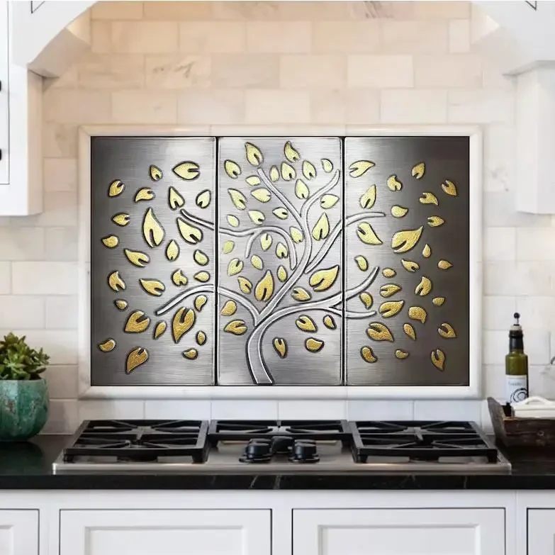 Exclusive, limited stainless tree with brass falling leaves
